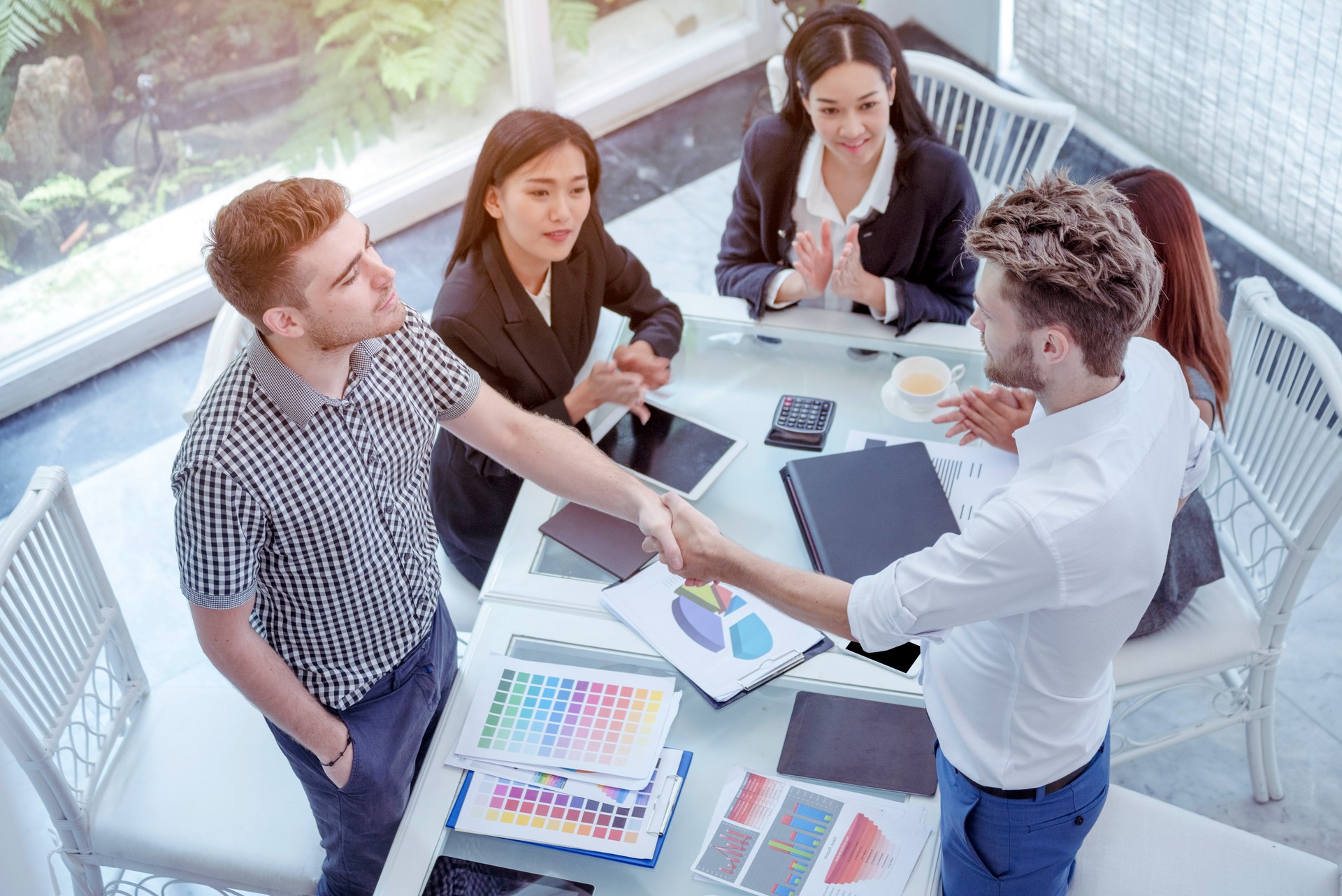 Team Business Partners shaking hands together to Greeting Start up small business in meeting room. Shakehand teamwork partners at modern office handshake together. Business mergers and acquisitions