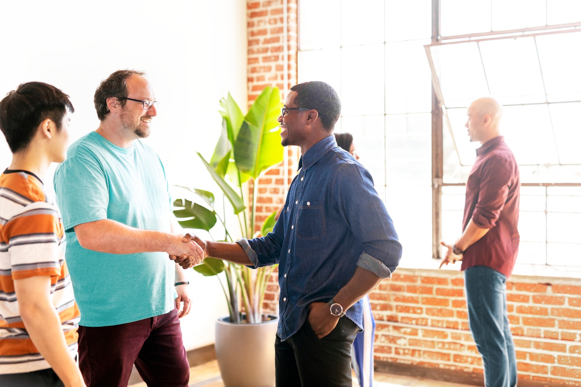 People shaking hands in a meeting